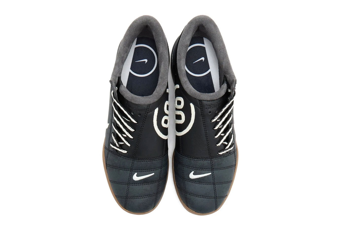Modern Nike Total 90 with white jacquard upper, black accents, gum sole, and iconic asymmetrical lacing