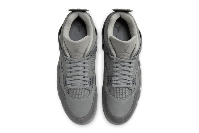 AJ4 'Wet Cement' sneaker in grey with nubuck leather and suede, inspired by Parisian cobblestone streets. The shoe showcases a rustic yet refined look, suitable for any urban setting.