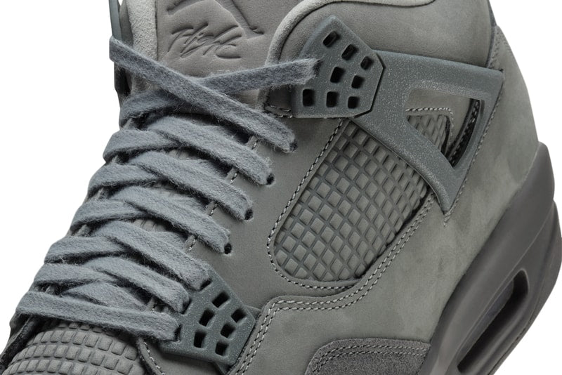 AJ4 'Wet Cement' sneaker in grey with nubuck leather and suede, inspired by Parisian cobblestone streets. The shoe showcases a rustic yet refined look, suitable for any urban setting.