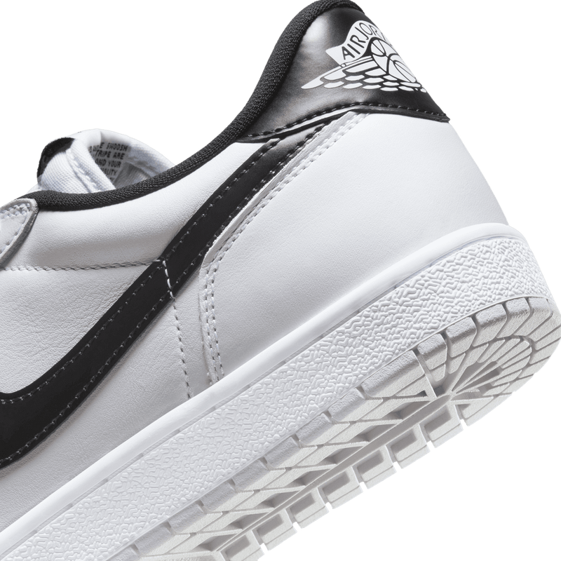 Air Jordan 1 Low '85 Metallic Black - White leather with metallic black Swoosh, heel tab, and grey outsole.