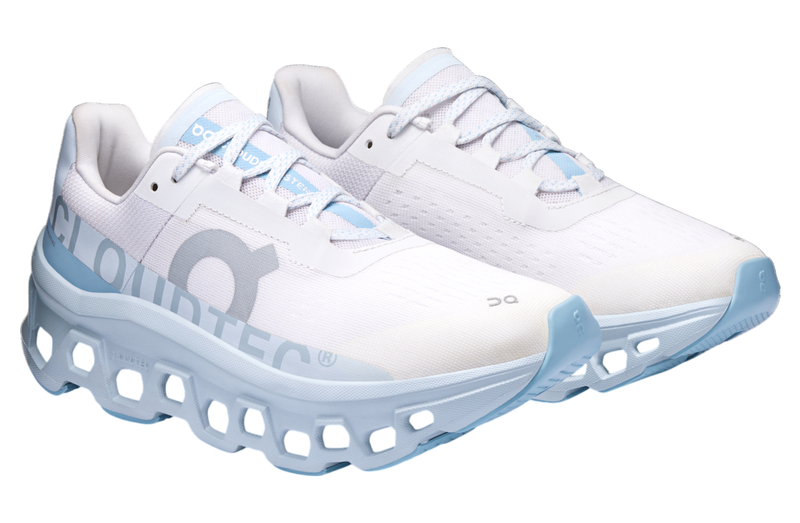 On Cloudmonster WMNS Frost / Wash running shoe with CloudTec cushioning, combining icy blue and neutral tones for a stylish, comfortable design.