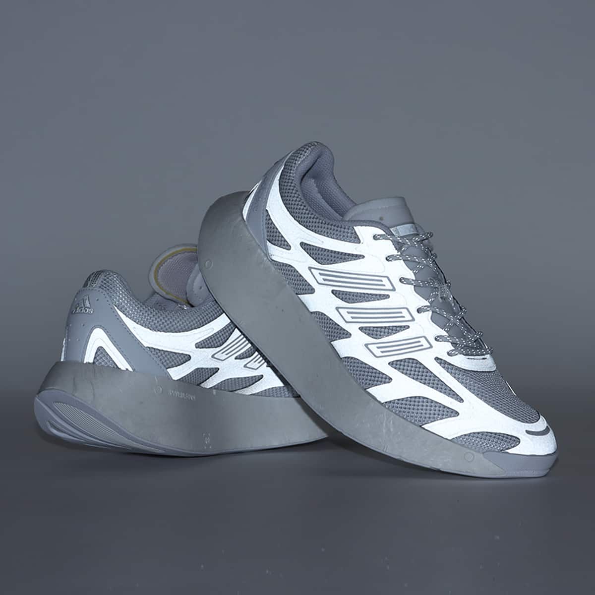 Adizero Arc shoes with Swirlfoam cushioning, a rocker-shaped sole, and a durable rubber outsole, inspired by 2000s running sneakers.