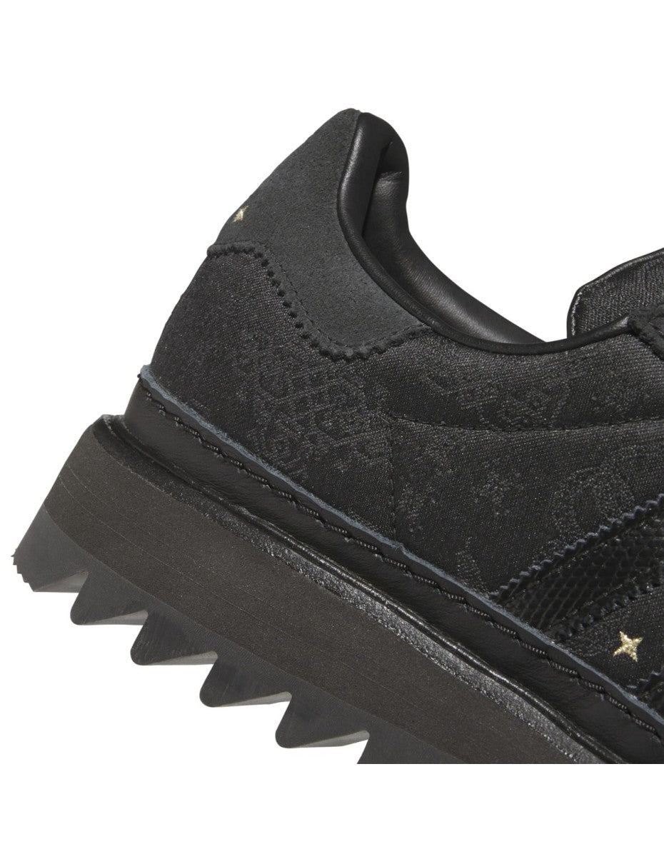 adidas Superstar x CLOT sneaker with snakeskin-patterned 3-Stripes, monogram print, gold details, red string accents, and a rippled outsole for a bold Lunar New Year tribute.