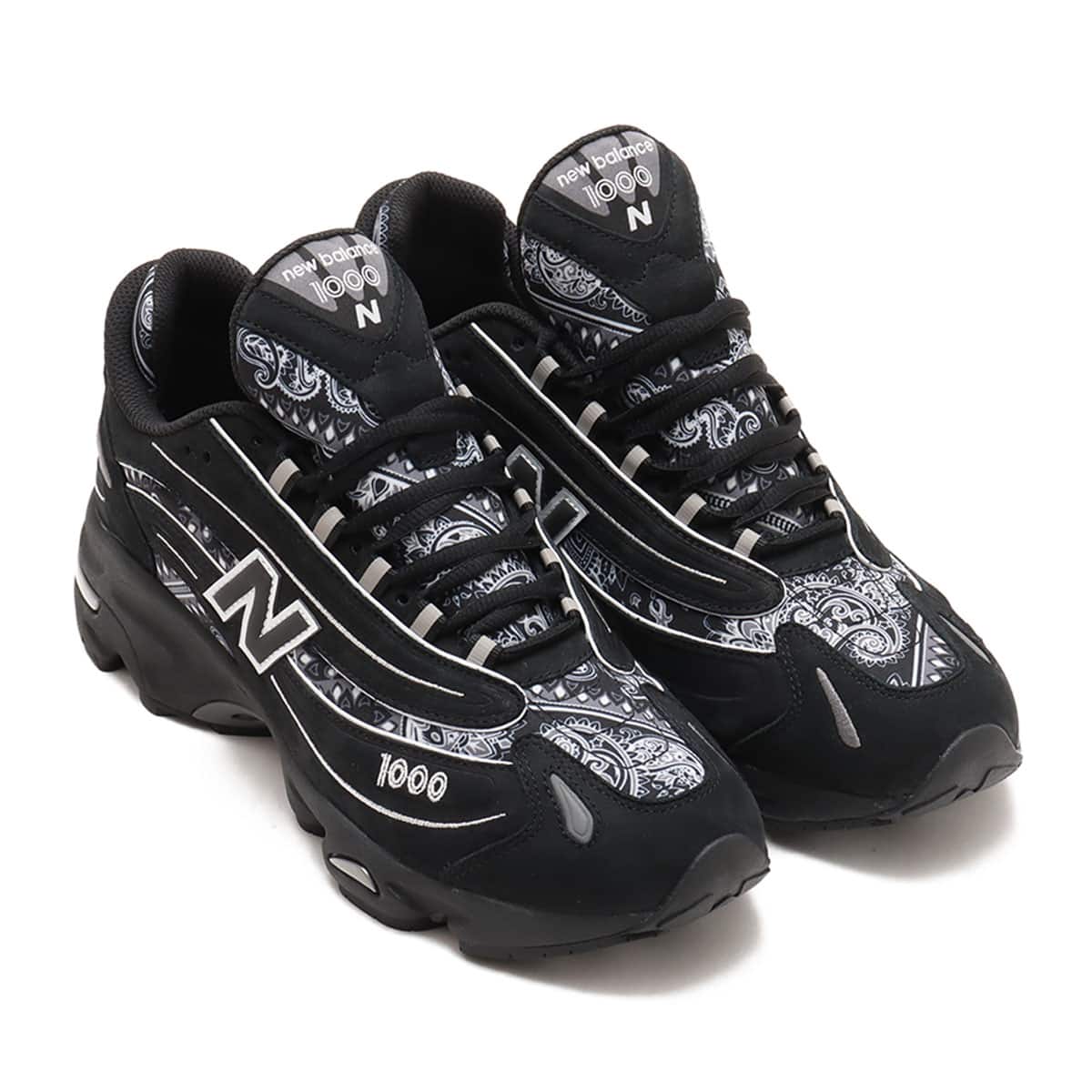 atmos x New Balance M1000 sneakers in black nubuck with bandana pattern details and monochrome color scheme