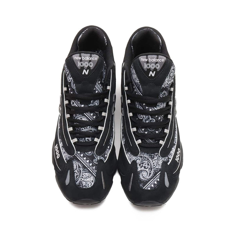 atmos x New Balance M1000 sneakers in black nubuck with bandana pattern details and monochrome color scheme