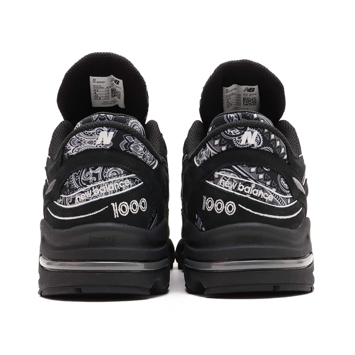 atmos x New Balance M1000 sneakers in black nubuck with bandana pattern details and monochrome color scheme