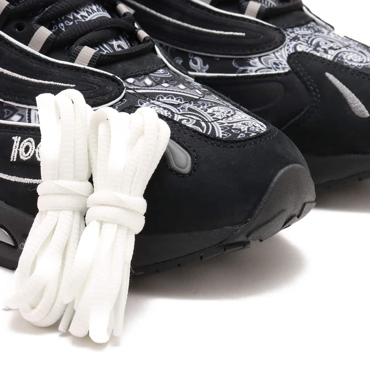 atmos x New Balance M1000 sneakers in black nubuck with bandana pattern details and monochrome color scheme