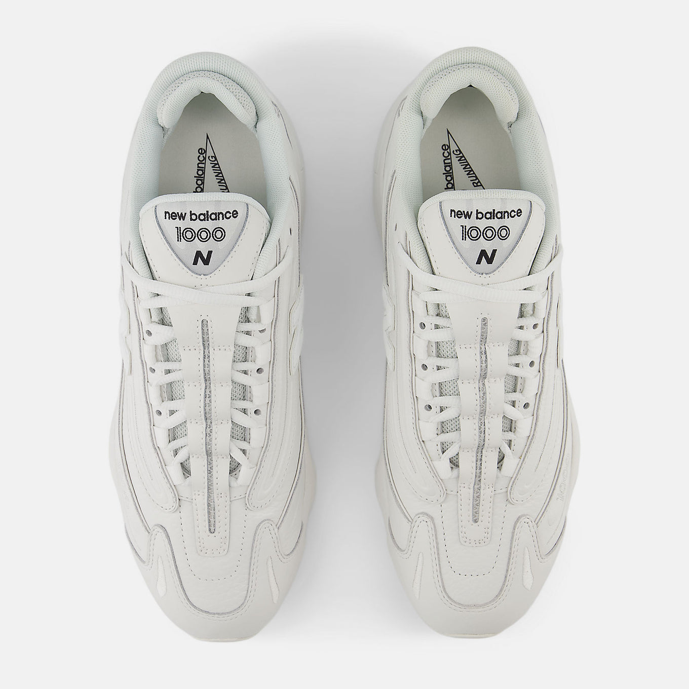 Reissued 1000 sneaker with a futuristic design, mesh underlays, leather overlays, and ABZORB cushioning for comfort and support.