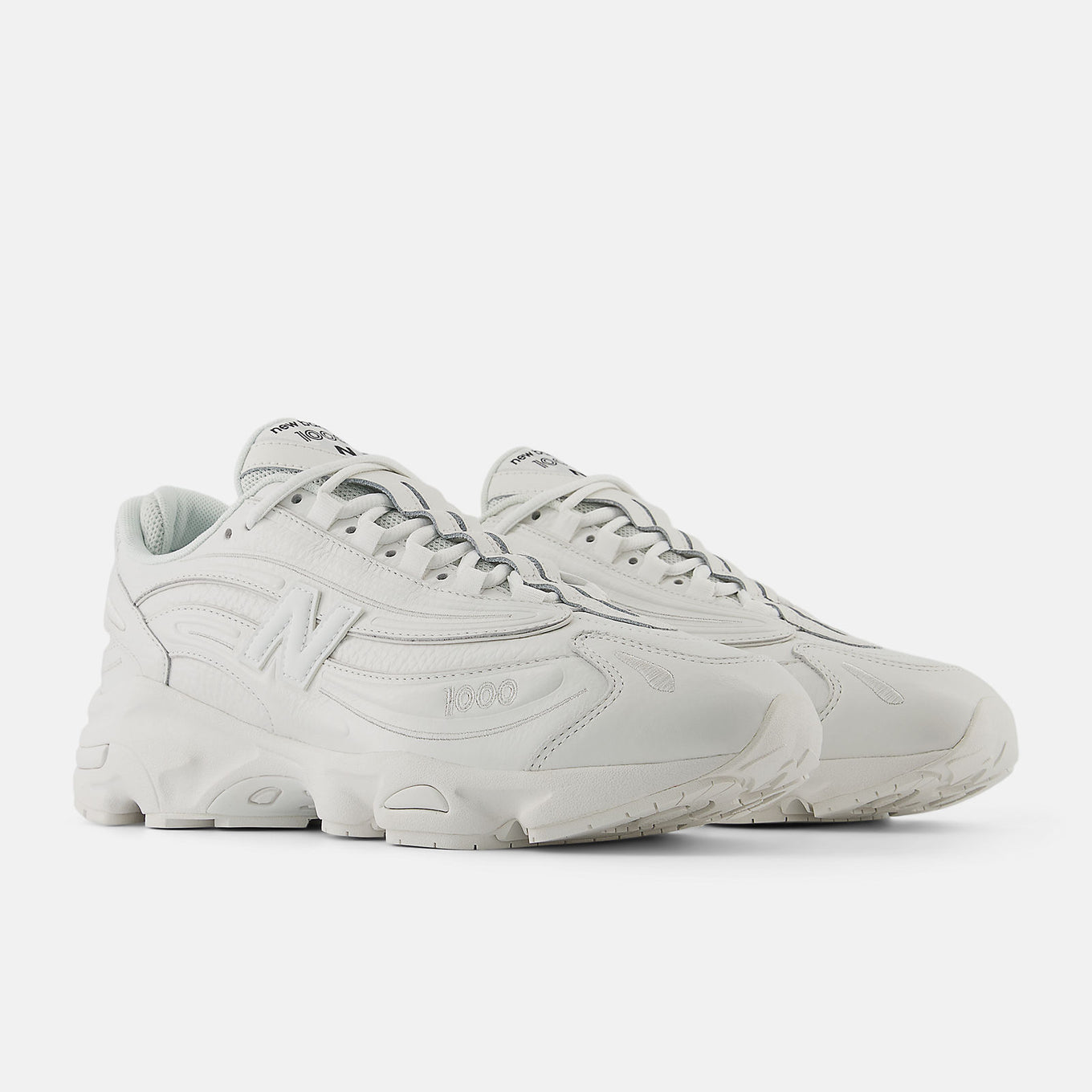 Reissued 1000 sneaker with a futuristic design, mesh underlays, leather overlays, and ABZORB cushioning for comfort and support.