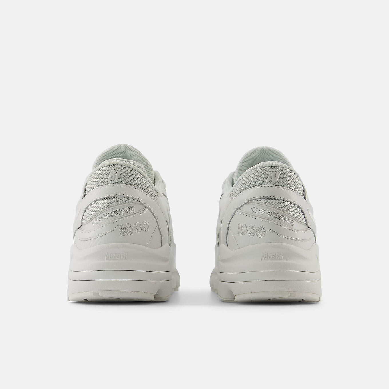 Reissued 1000 sneaker with a futuristic design, mesh underlays, leather overlays, and ABZORB cushioning for comfort and support.