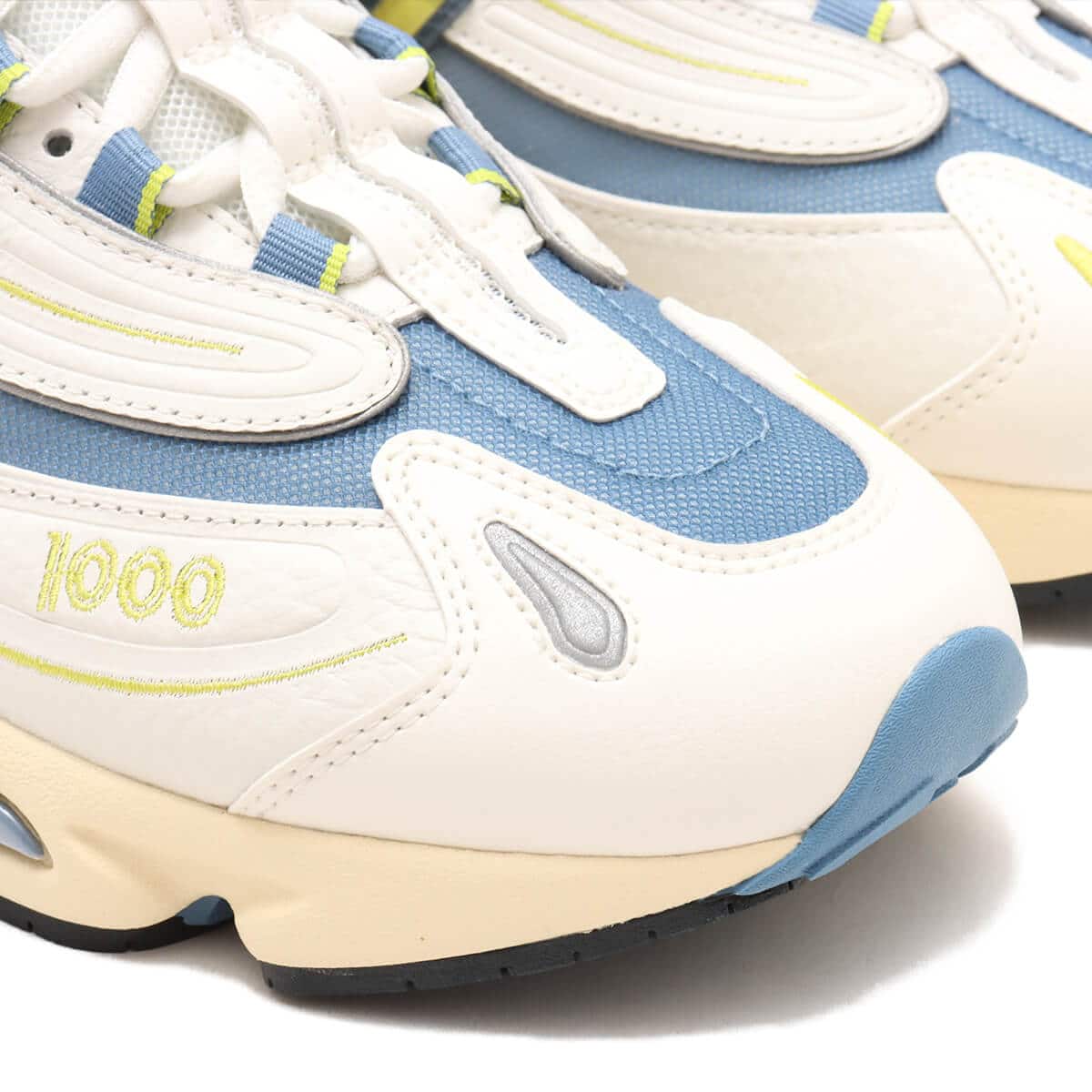 Iconic M1000 training shoe reissue in vibrant colors with cushioned Full ABZORB heel and sleek synthetic leather and mesh design.

