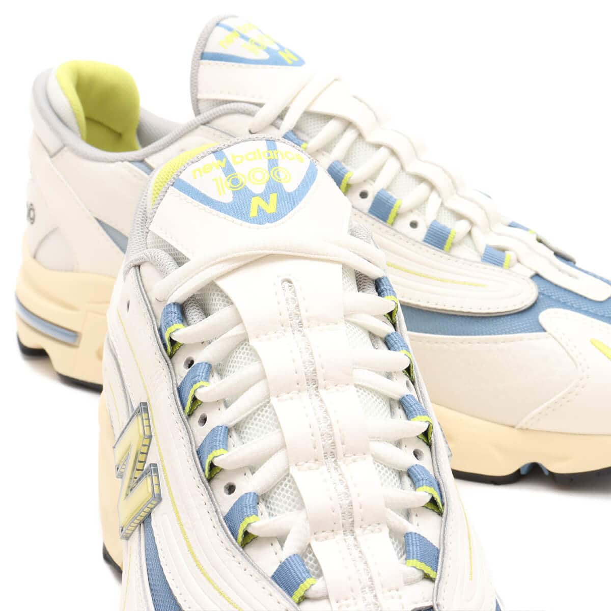 Iconic M1000 training shoe reissue in vibrant colors with cushioned Full ABZORB heel and sleek synthetic leather and mesh design.

