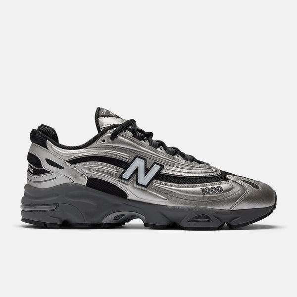 New Balance 1000 sneakers with inverted mesh and suede upper, segmented sole, and ABZORB cushioning in a retro-futuristic design