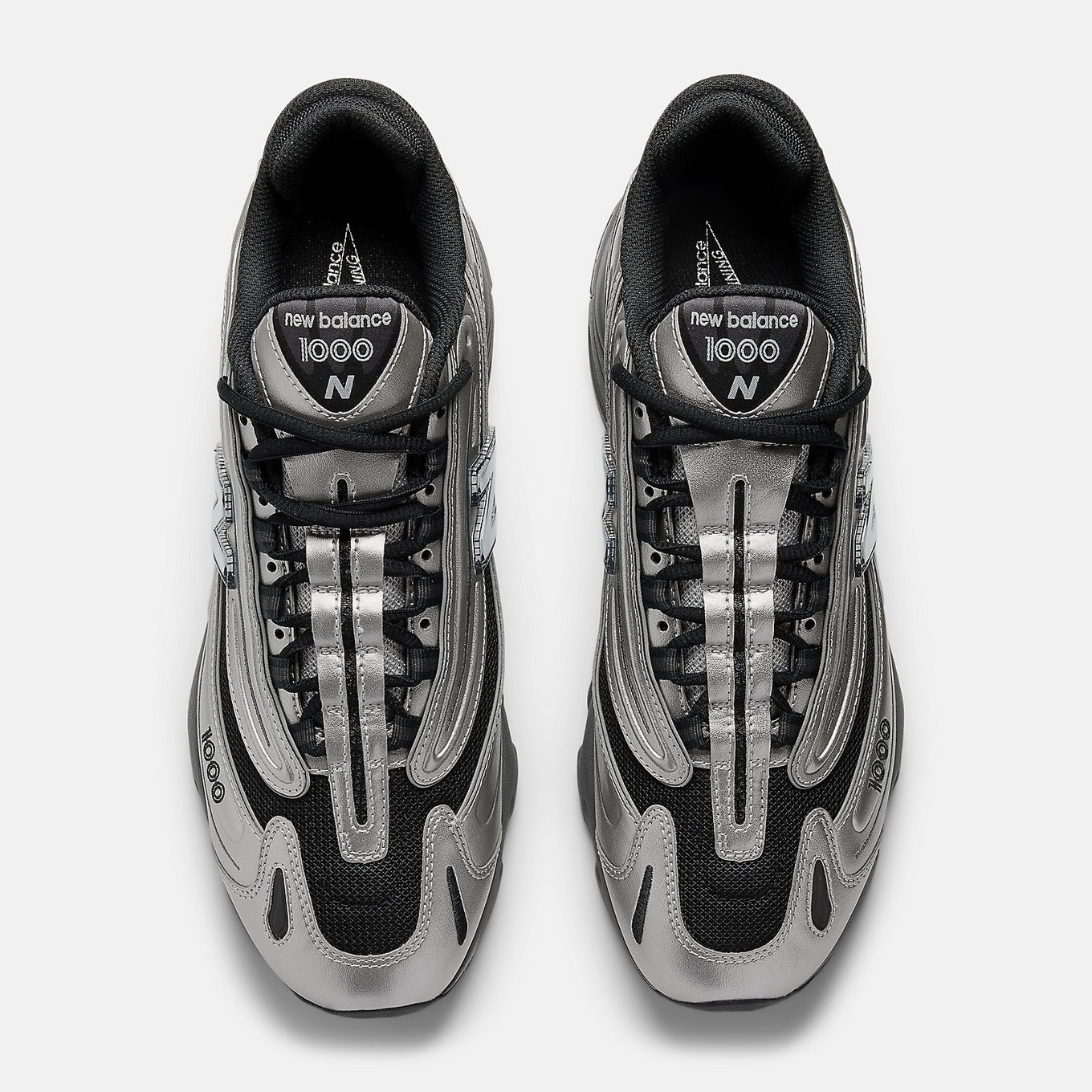 New Balance 1000 sneakers with inverted mesh and suede upper, segmented sole, and ABZORB cushioning in a retro-futuristic design