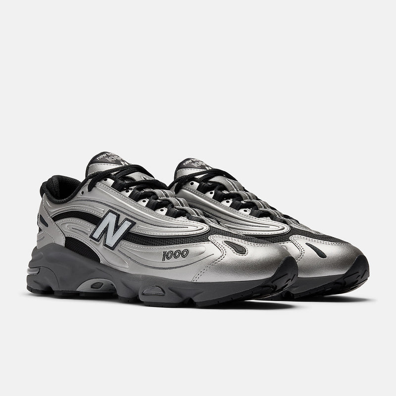 New Balance 1000 sneakers with inverted mesh and suede upper, segmented sole, and ABZORB cushioning in a retro-futuristic design