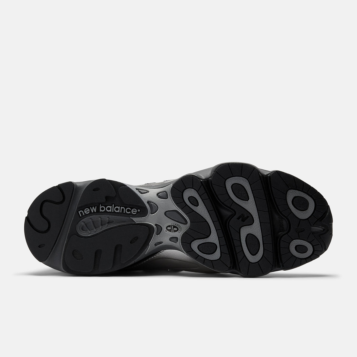 New Balance 1000 sneakers with inverted mesh and suede upper, segmented sole, and ABZORB cushioning in a retro-futuristic design