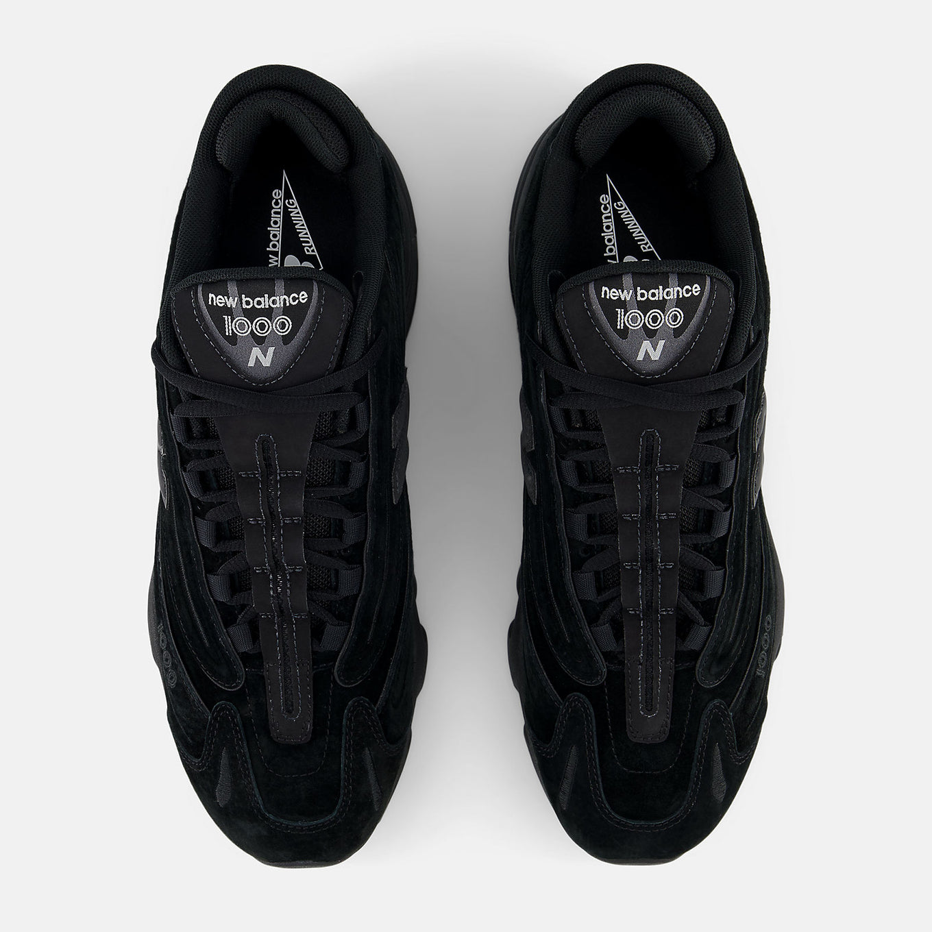 New Balance 1000 sneaker with futuristic design, featuring mesh underlays, leather overlays, and a segmented sole with ABZORB cushioning.