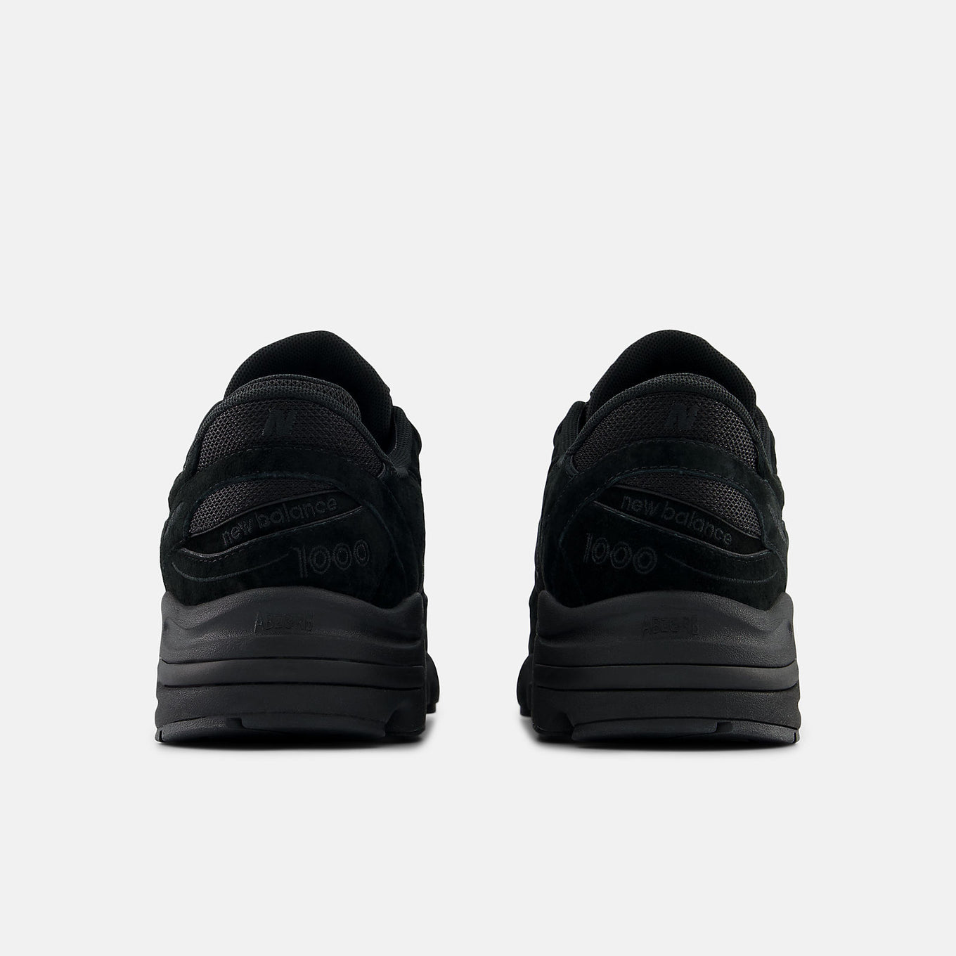 New Balance 1000 sneaker with futuristic design, featuring mesh underlays, leather overlays, and a segmented sole with ABZORB cushioning.