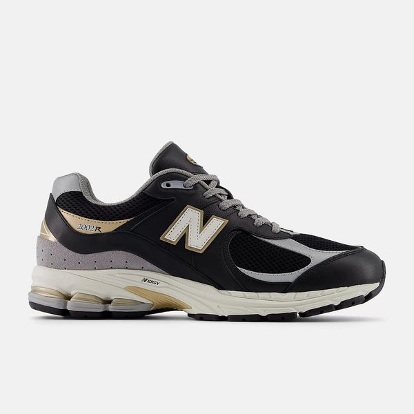 New Balance M2002RPO sneakers with leather upper, black, sea salt, and metallic gold details, offering premium comfort and durability.