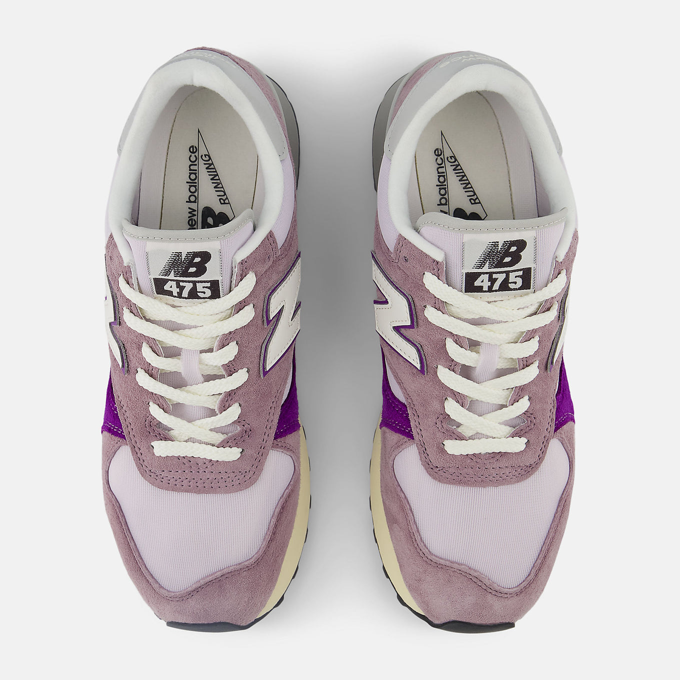 New Balance 475 sneaker from 1986 with suede and leather overlays, classic mesh base, lugged outsole, and reflective detailing.