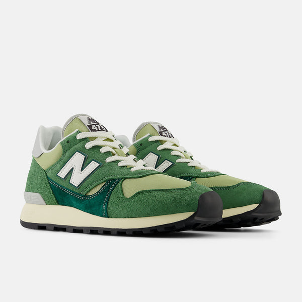 New Balance 475 sneaker from 1986 with suede and leather overlays, classic mesh base, lugged outsole, and reflective detailing.