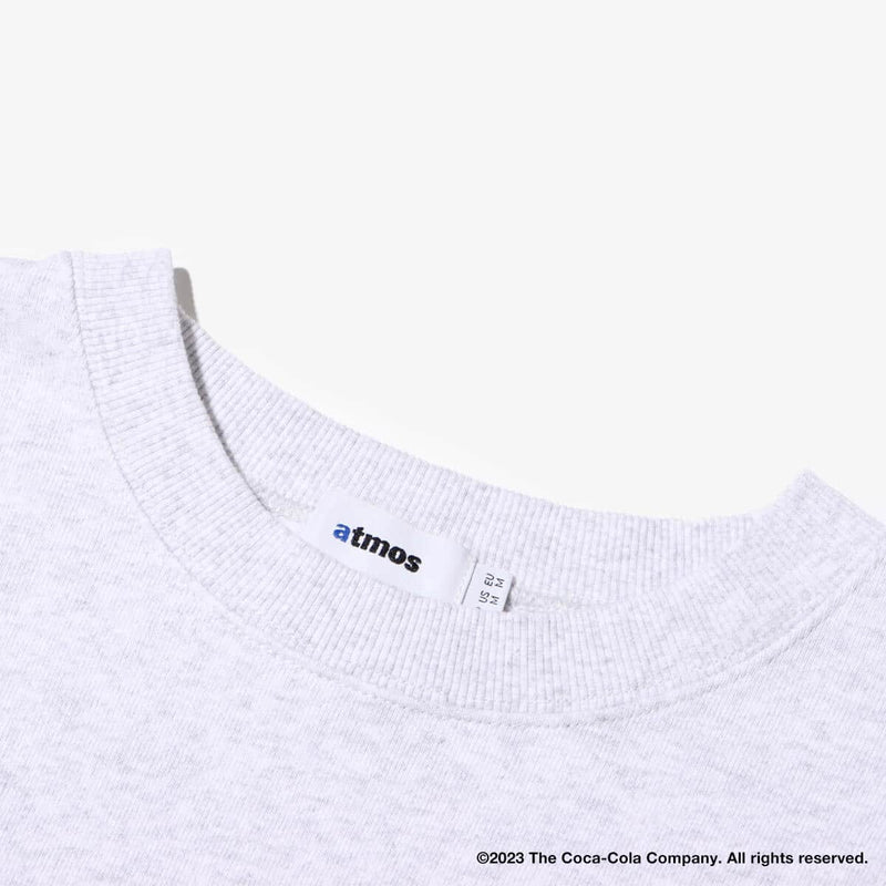 Coca-Cola x atmos crew neck sweatshirt with embroidered front motif and printed lyrics, made from heavyweight cotton fleece.
