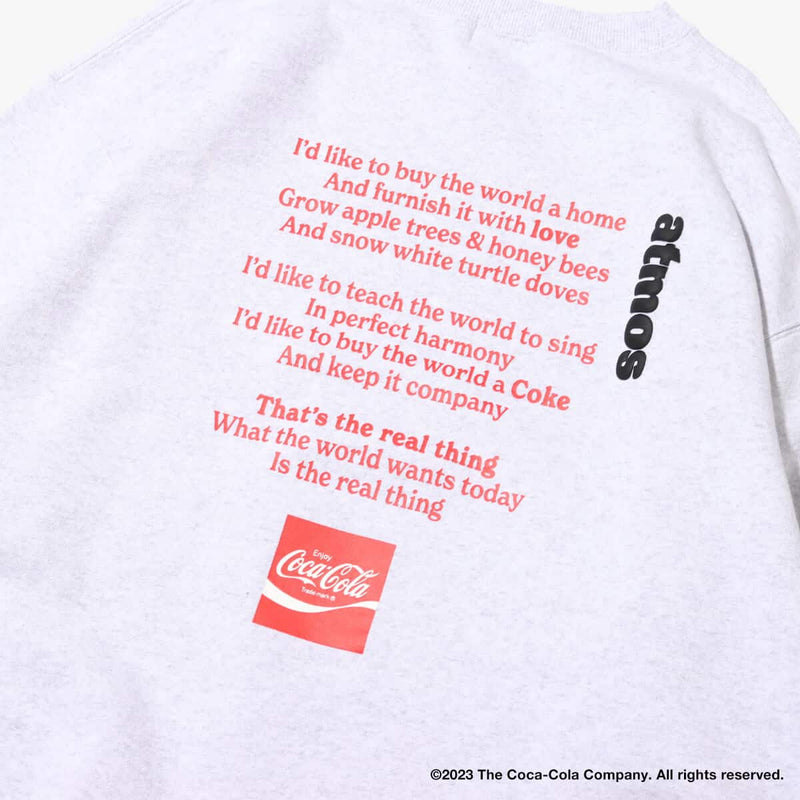 Coca-Cola x atmos crew neck sweatshirt with embroidered front motif and printed lyrics, made from heavyweight cotton fleece.