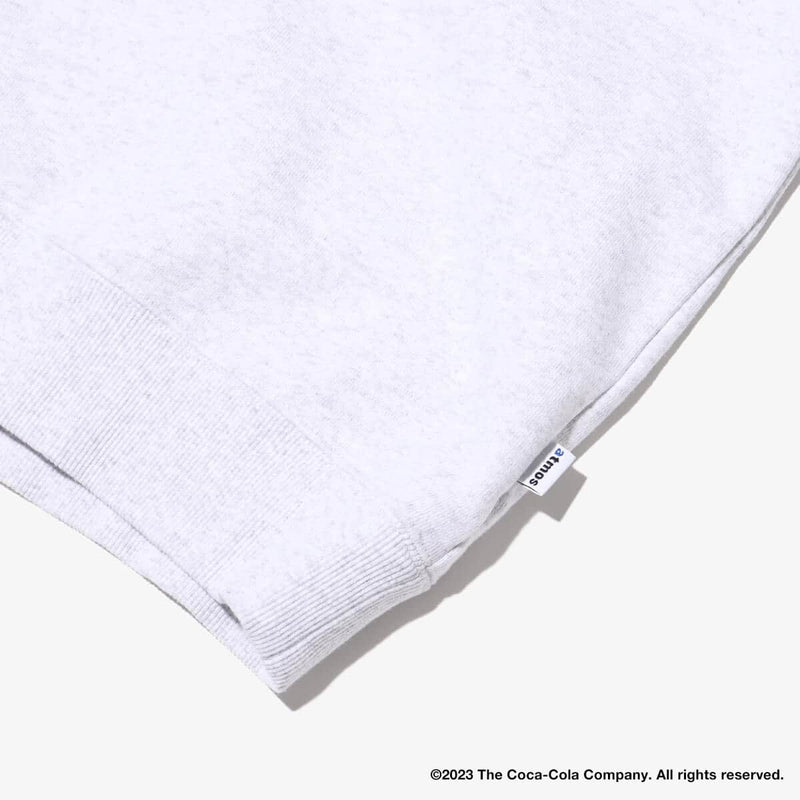 Coca-Cola x atmos crew neck sweatshirt with embroidered front motif and printed lyrics, made from heavyweight cotton fleece.