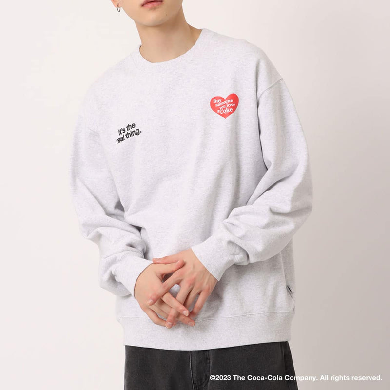 Coca-Cola x atmos crew neck sweatshirt with embroidered front motif and printed lyrics, made from heavyweight cotton fleece.