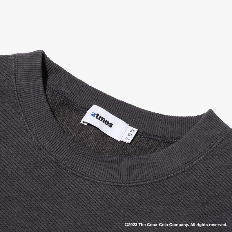 Coca-Cola x atmos crew neck sweatshirt with embroidered front motif and printed lyrics, made from heavyweight cotton fleece.