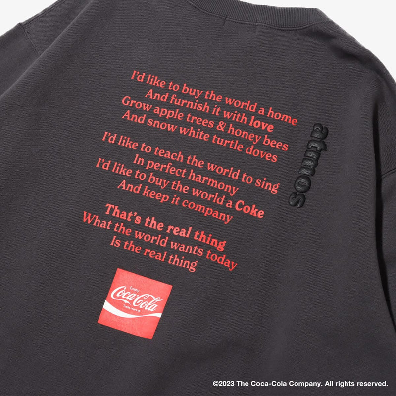 Coca-Cola x atmos crew neck sweatshirt with embroidered front motif and printed lyrics, made from heavyweight cotton fleece.