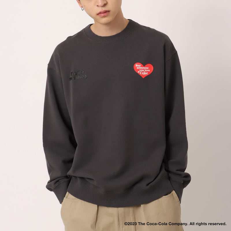Coca-Cola x atmos crew neck sweatshirt with embroidered front motif and printed lyrics, made from heavyweight cotton fleece.