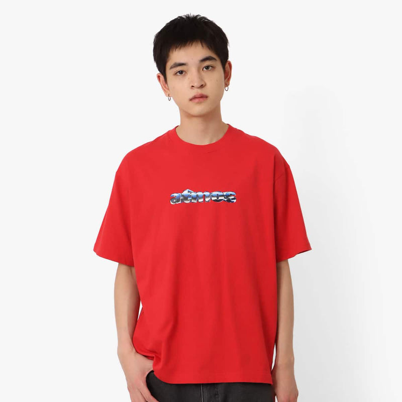 Short-sleeved T-shirt with metallic rubber-printed atmos logo, soft fabric, relaxed fit, and pin name tag on left hem.