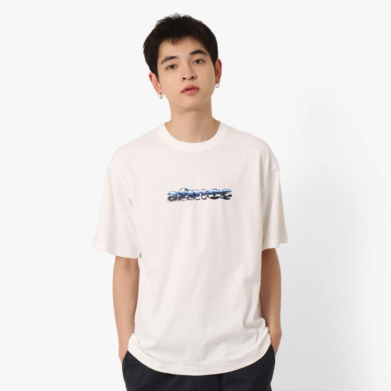Short-sleeved T-shirt with metallic rubber-printed atmos logo, soft fabric, relaxed fit, and pin tag on left hem.