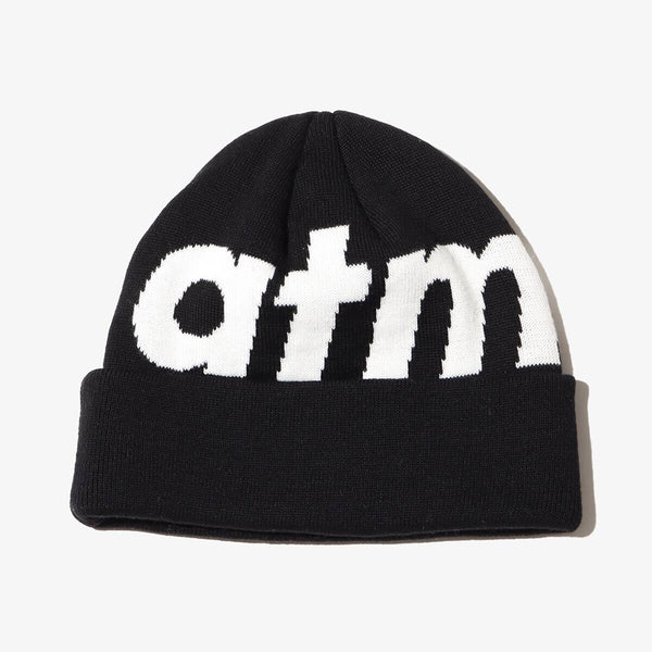 Knit cap with "atmos" logo, jacquard zebra and leopard patterns, and made from thick acrylic-blend yarn for warmth.