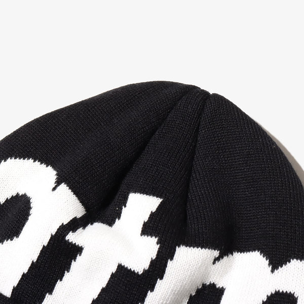 Knit cap with "atmos" logo, jacquard zebra and leopard patterns, and made from thick acrylic-blend yarn for warmth.