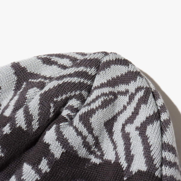 Knit cap with "atmos" logo, jacquard zebra and leopard patterns, and made from thick acrylic-blend yarn for warmth.