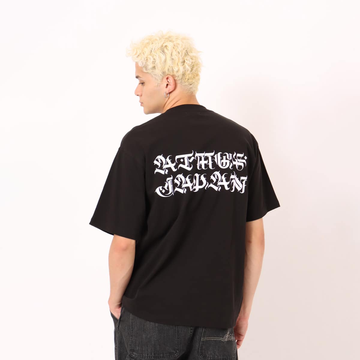 Short-sleeve T-shirt with a textured jersey fabric and bold Old English font motif printed in thick rubber on the front and back.





