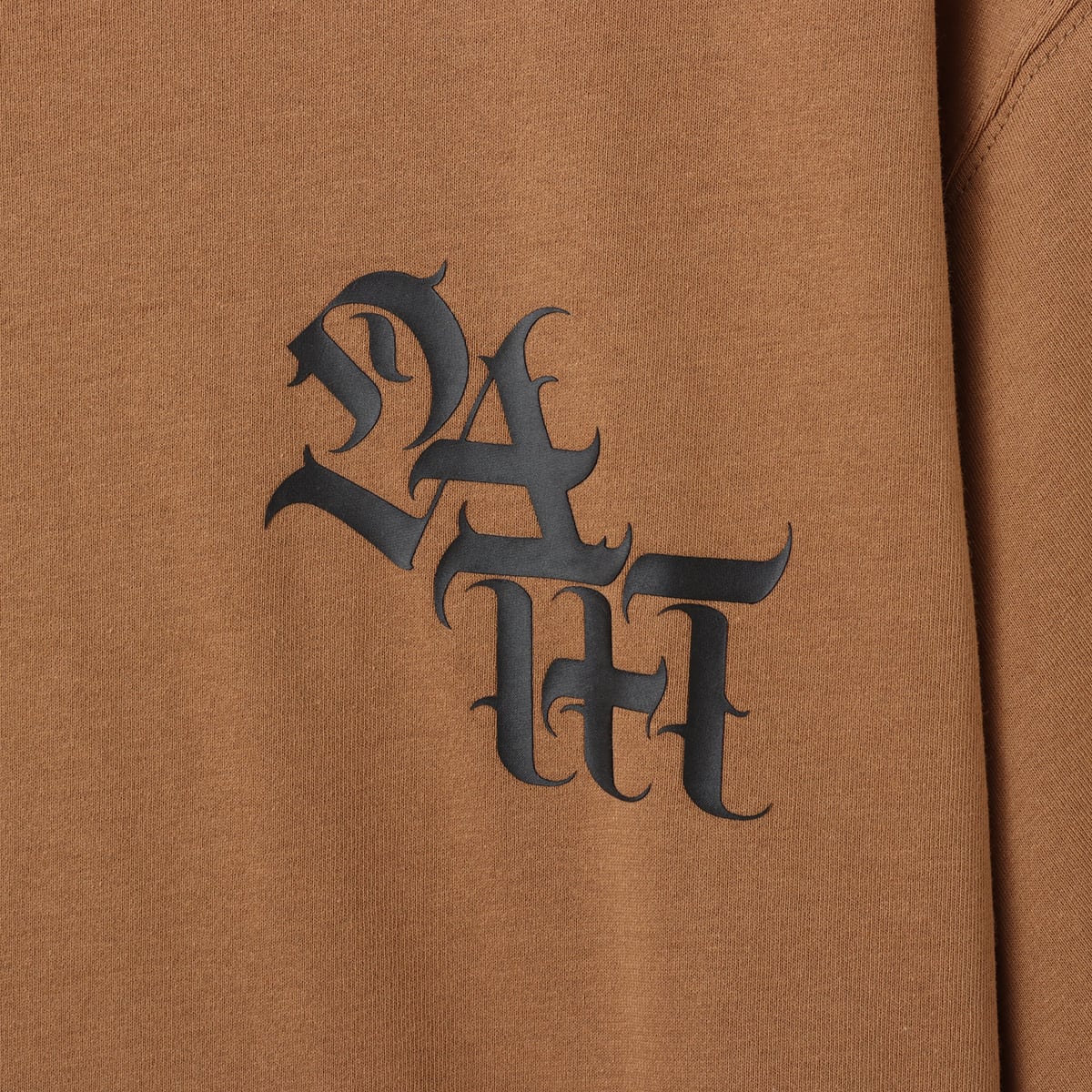 Short-sleeve T-shirt with a textured jersey fabric and bold Old English font motif printed in thick rubber on the front and back.





