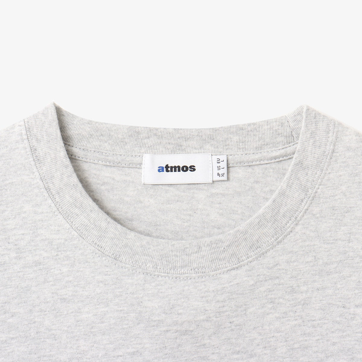 ATMOSPHERE logo short-sleeved T-shirt with vintage black finish and blue pistag at left hem