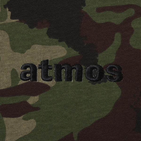 Classic atmos T-shirt with embroidered logo, blue pist tag on left hem, and thick 9-ounce American cotton fabric for a durable, textured feel. 