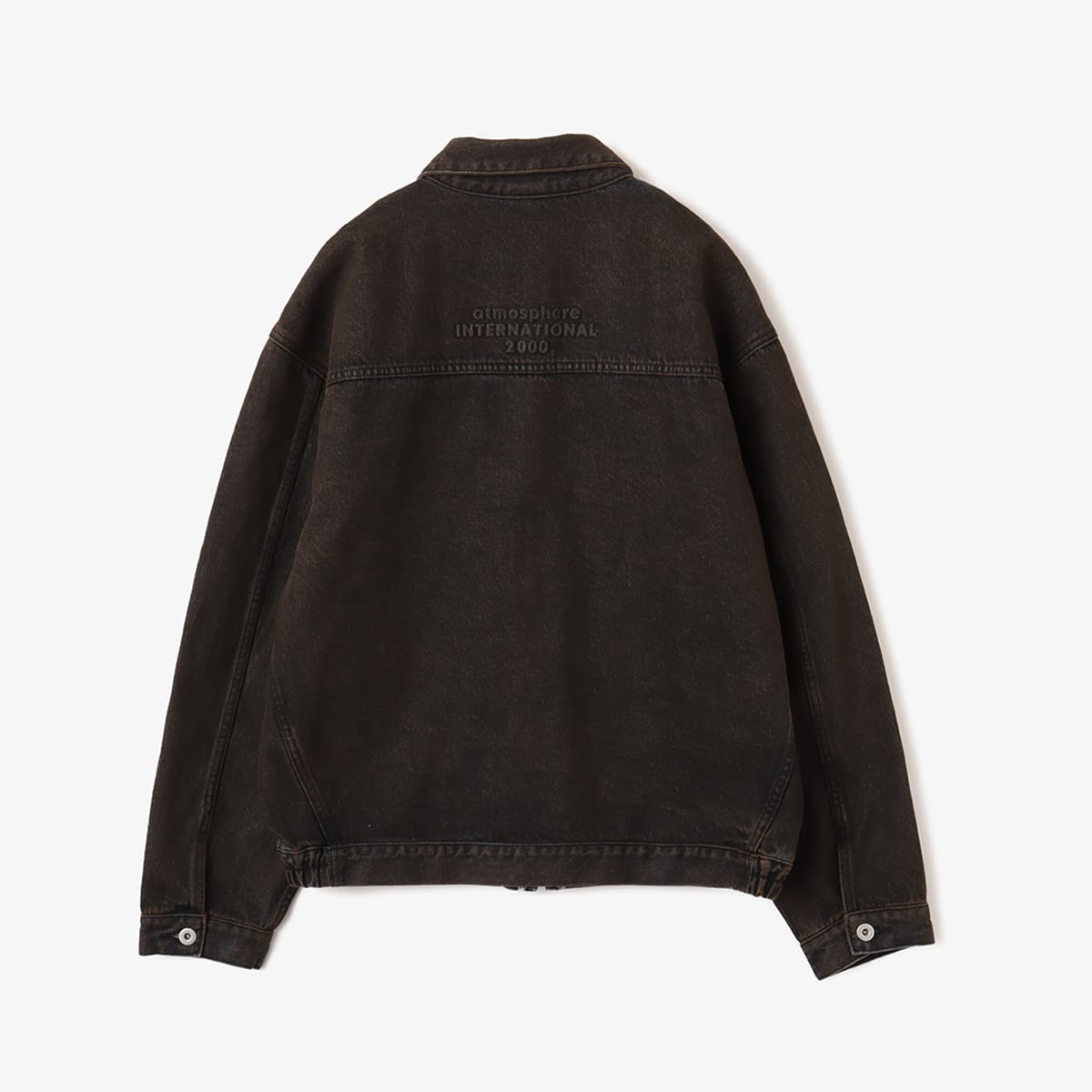 Boxy denim jacket with vintage wash, workwear details, and relaxed fit, styled with cargo pants.