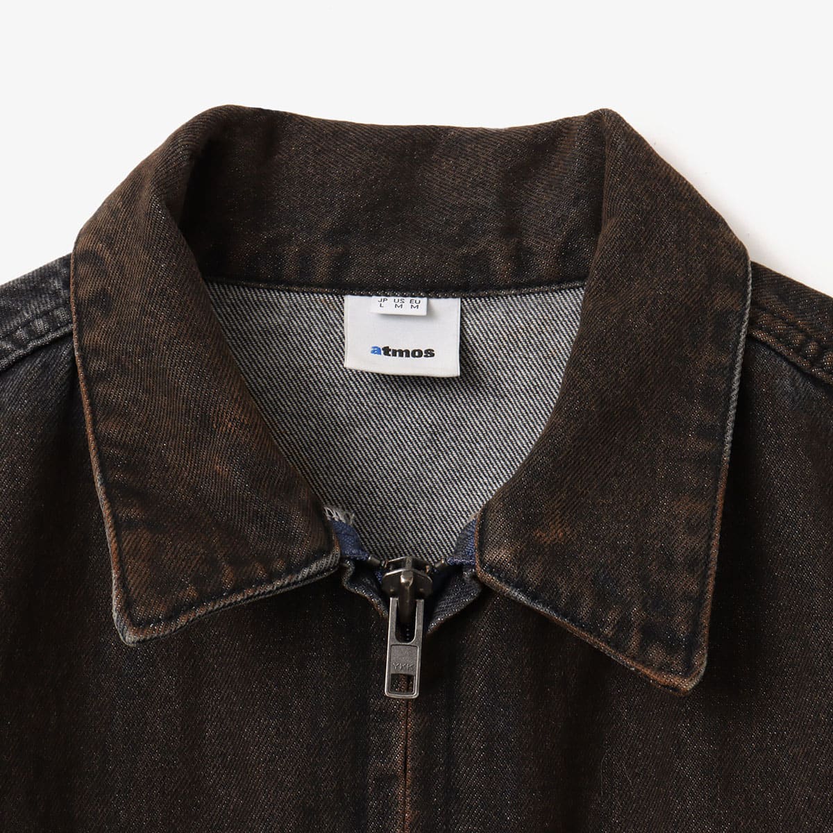 Boxy denim jacket with vintage wash, workwear details, and relaxed fit, styled with cargo pants.