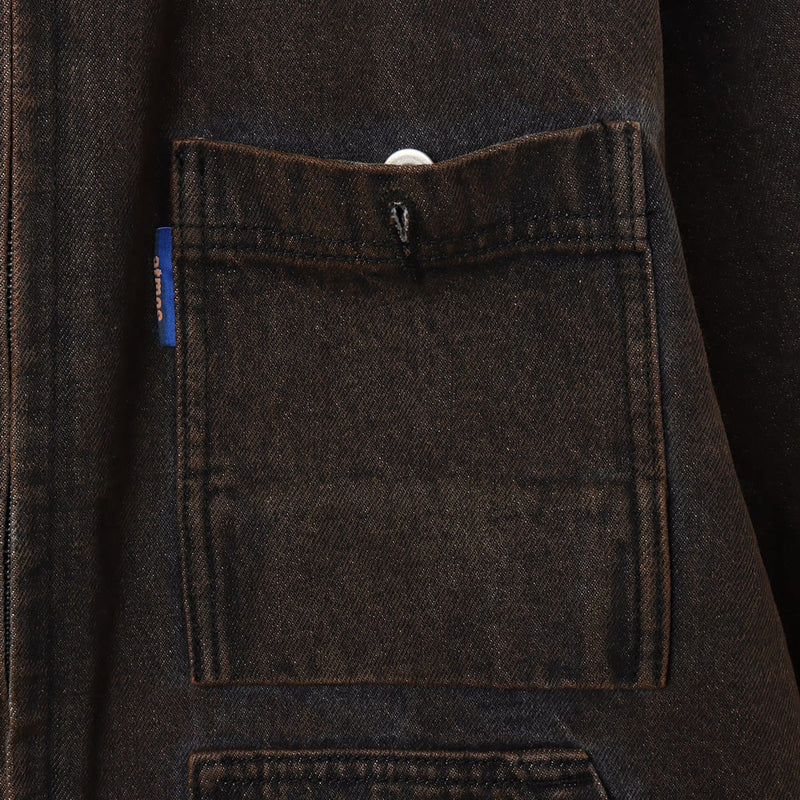 Boxy denim jacket with vintage wash, workwear details, and relaxed fit, styled with cargo pants.