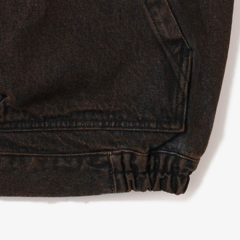 Boxy denim jacket with vintage wash, workwear details, and relaxed fit, styled with cargo pants.