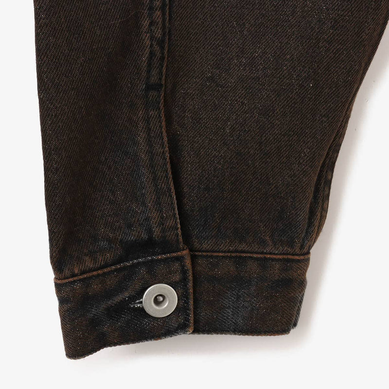 Boxy denim jacket with vintage wash, workwear details, and relaxed fit, styled with cargo pants.