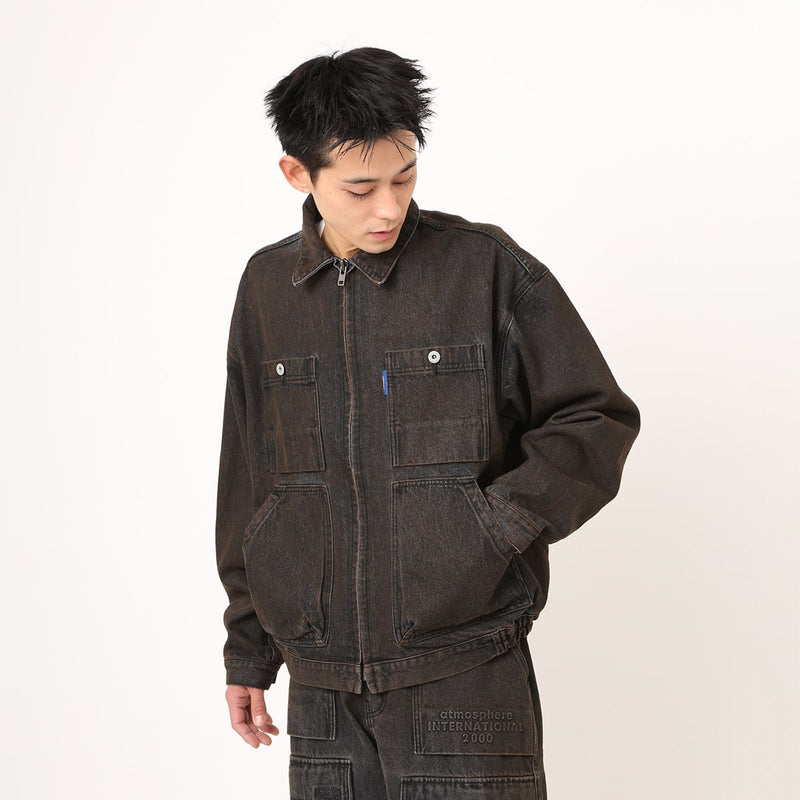 Boxy denim jacket with vintage wash, workwear details, and relaxed fit, styled with cargo pants.