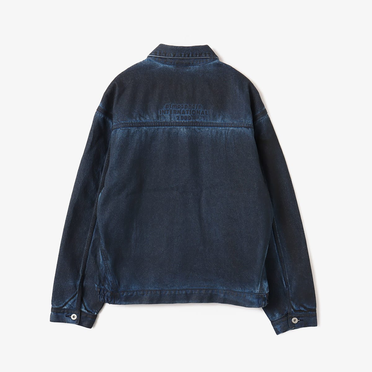 Boxy denim jacket with vintage wash, workwear details, and relaxed fit, styled with cargo pants.