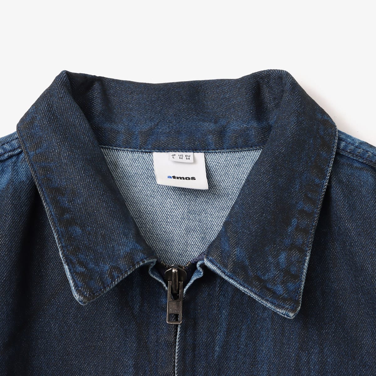 Boxy denim jacket with vintage wash, workwear details, and relaxed fit, styled with cargo pants.