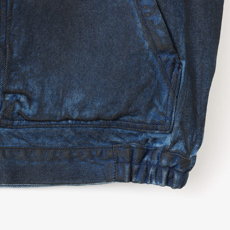 Boxy denim jacket with vintage wash, workwear details, and relaxed fit, styled with cargo pants.